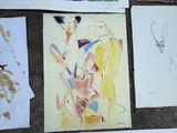 many different colored pencils on the floor next to a guitar