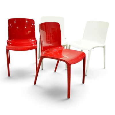 three red and white chairs sitting next to each other on a white surface