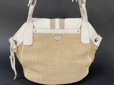 an image of a white and beige purse on a black background