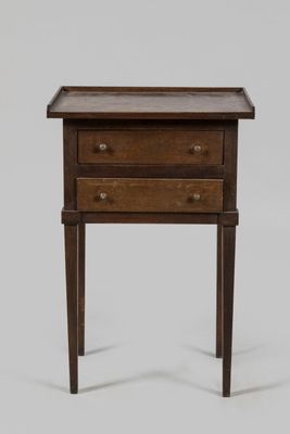 a small wooden table with two drawers and a drawer underneath it