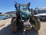 a tractor that is parked on the side of the road