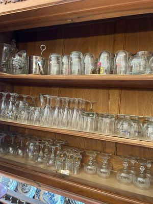 many glasses on the shelves in the room