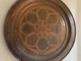 a metal plate with a design on it on the wall