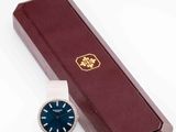 a watch sitting next to a box with a watch on it