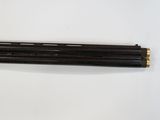 two black and gold pencils sitting on top of a white surface