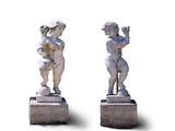 pair of statues of a boy and a girl holding a flower