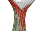 a glass vase that has a red and green design on it