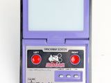 an old gameboy with a purple case sitting on top of a white surface
