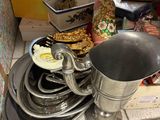 a pile of dishes and pans on the floor