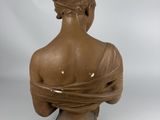 statue of a woman with a bird on her head