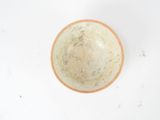 a bowl that is sitting on a white surface
