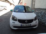 a small white car parked on the side of the street