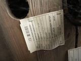 a cat that is sitting in a box with a ticket