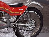 a red motorcycle that is parked in a garage