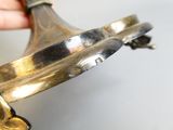 a person holding a metal object in their hand