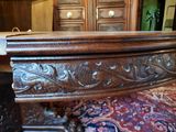a wooden table with carvings on it in a room