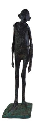 statue of a man with a hat on his head standing on a green base