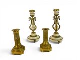 three antique brass candlesticks on a white background with a white background