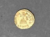 an image of a gold coin sitting on top of a table