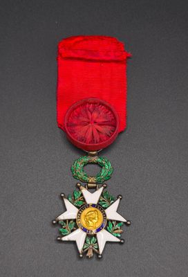 a close up of a medal with a red ribbon around it