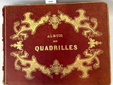 an old red and gold book with a gold border on top of it