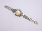 a close up of a wrist watch on a white surface