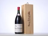 a bottle of wine sitting next to a wooden box