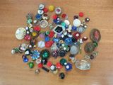 a pile of assorted jewelry on a wooden table