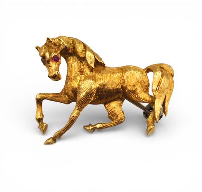 gold plated horse brooch with ruby eyes and mane
