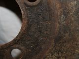a rusted piece of metal with holes in it