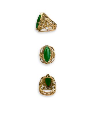 a set of three gold and green rings