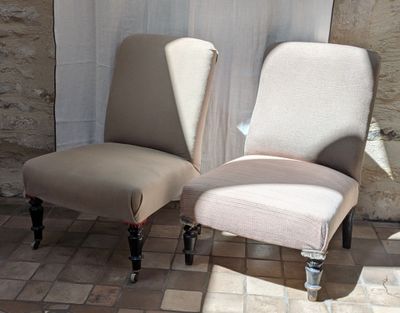 two chairs sitting next to each other on a tiled floor