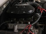 a small engine in a car with a red wire attached to it