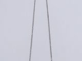 a close up of a necklace on a white surface