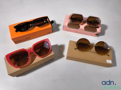three pairs of sunglasses in a box on a white surface