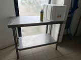 a microwave on a table in front of a window