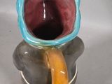 a vase that has a handle on it and a handle on it