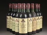 six bottles of wine are lined up in a row on a table