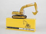 a toy excavator sitting on top of a yellow box