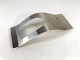 a metal object on a white surface with a white background