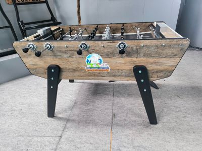 a foosball table in the corner of a room