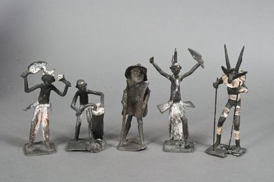 several figurines of people with hats and hats are standing in a line