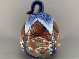 a blue and white bell with a bird on it