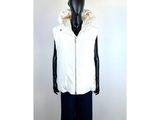 a mannequin wearing a white jacket and black pants