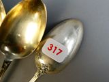 three spoons that have a price tag on them