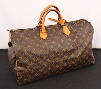 a louis vuittou bag sitting on a black surface