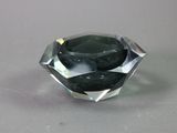 a close up of a black diamond on a gray surface