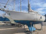 a boat that is sitting on a stand in the sand