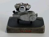 a metal sculpture of a motorcycle on top of a book