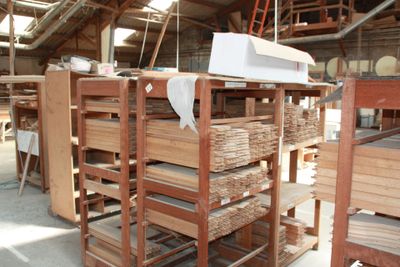 many stacks of wood in a warehouse with a white box on top of them